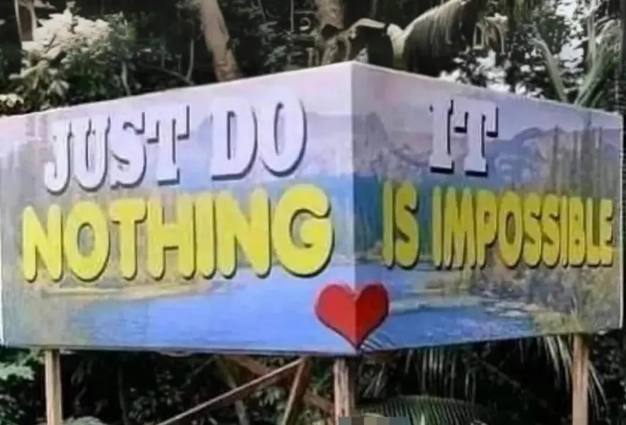 مردی که خم شده و میخندد پیشنمایش تابلو طنزآمیز با نوشته «فقط هیچ کاری نکن. این غیرممکن است» و قلبی بین عبارات